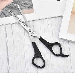 Macro view of the serrated stainless steel blade on pet thinning and grooming shears