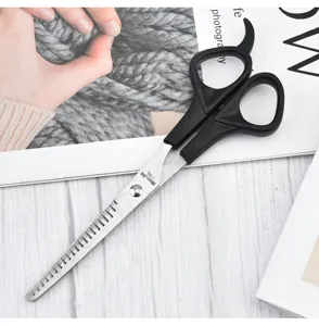 Macro detail view of stainless steel pet thinning scissors with ergonomic black handles