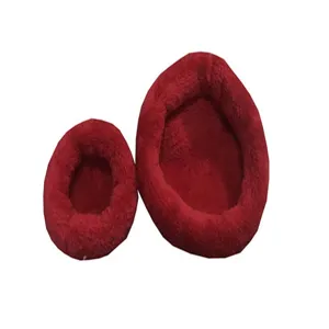 Macro view of two deep red plush warm nests for small pets in different sizes