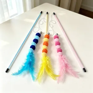Giocattolo per gatti con piuma di bruco e pon pon colorati per gioco interattivo.