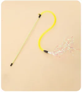 Close-up detail of yellow elastic mesh cat teaser toy with colorful shiny tassels and bell.