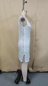 Side detail view of white hollow-out knit beach dress, perfect swimwear cover-up style.