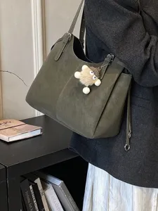 Large olive green suede tote bag for autumn winter with a cute plush monster charm