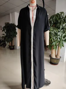 Detail view of the black and white color block long shirt dress, featuring contrast lapel.
