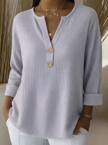 Close-up detail of the women's light purple waffle knit V-neck long sleeve top buttons.