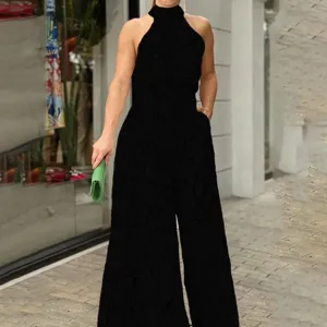 Black halter neck sleeveless jumpsuit detail view, showcasing the stylish print and elegant fit.
