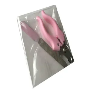 Close-up view of a pink pet nail clipper and file set inside clear plastic packaging bag