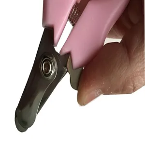 Close-up of pink pet nail clipper showing stainless steel blade and spring mechanism