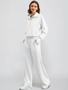 Detailed view of the women casual white half-zip sweatshirt and wide leg pants tracksuit.