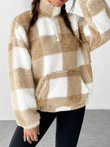 Brown white plaid fleece half-zip sweatshirt detail, cozy sherpa texture and front pocket view.