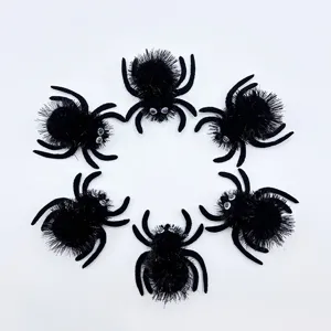 Detailed view of six fuzzy black Halloween spiders with googly eyes arranged in a circle.