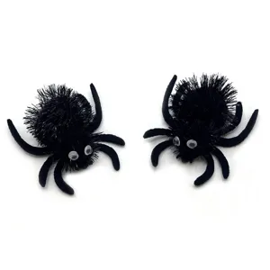 Detail view of two fuzzy black Halloween spider toys with googly eyes for pets