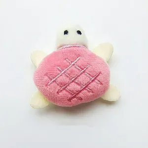 Detailed close-up of cute pink plush turtle toy, featuring soft fabric and lovely design.