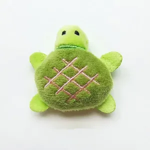 Cute plush turtle cat toy detail view, soft fabric material with pink embroidery design.