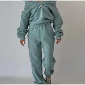 Detail shot of the fleece hoodie and sweatpants set, showing the cozy zipper neckline and soft fabric texture.