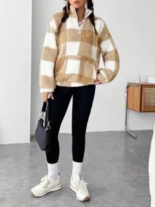 Detailed view of women's autumn winter half-zip brown white plaid fleece pullover top.