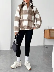 Detailed shot of the stylish half-zip brown and white checkered fuzzy pullover sweatshirt.