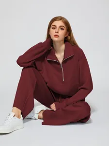 Close-up detail of women's half-zip sweatshirt and wide-leg trousers lounge set.