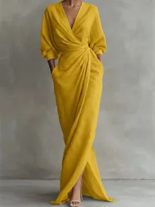 Elegant yellow v-neck maxi dress with long sleeves and waist wrap for women summer vacation.