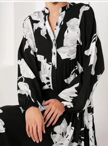 Black and white floral print long sleeve maxi dress detail, elegant collar and button front.