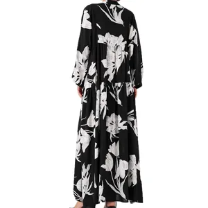 Elegant black long sleeve maxi dress with striking white floral print for chic styling.