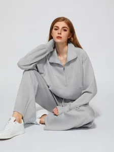 Grey half-zip sweatshirt and wide-leg sweatpants detail view, comfortable casual outfit.