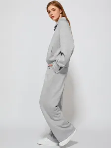 Detailed view of the stylish casual grey half-zip sweatshirt and wide-leg sweatpants set.