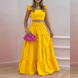 Women vibrant yellow two-piece set with ruffled crop top and tiered long skirt detail view.