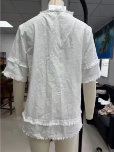 White casual short sleeve blouse featuring loose fit design, elegant fringe trim on hem and sleeves.