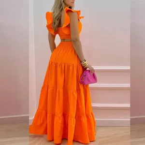 Women orange two-piece set featuring a ruffle crop top and a stylish tiered maxi skirt outfit