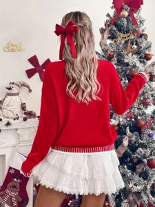 Festive red knit sweater detail shot showcasing soft ribbed cuffs and cozy holiday atmosphere.