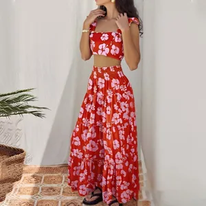 Detailed view of the red floral print crop top and tiered long skirt outfit in a natural setting.