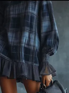 Blue plaid long sleeve dress detail showcasing ruffled mesh cuffs and hem design.