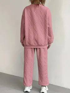 Pink cable knit sweater and pants set back view showing detailed texture and loose fit style.