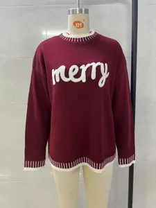 Burgundy knit sweater detail showing the front white merry letter weaving and ribbed crewneck.