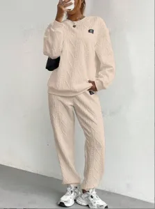 Detailed view of the beige cable-knit sweater and sweatpants lounge set with textured weave.