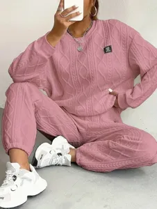 Pink knit textured pullover and trousers lounge set detail showing the fabric and design.