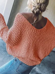 Close-up detail of the women's oversized V-neck knitted pullover sweater in coral orange.