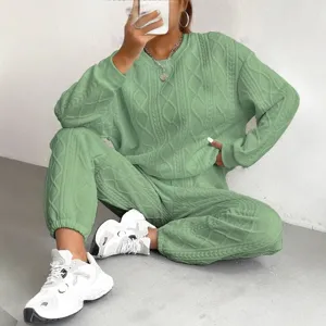 Women green knitted two-piece set casual long sleeve sweater and trousers for autumn.