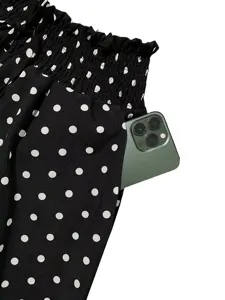 Black and white polka dot wide leg pants pocket detail showcasing high smocked waist.