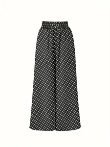 Close-up detail of high waist elastic drawstring with classic black and white polka dots.