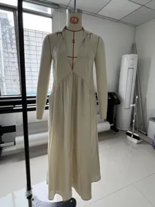 Robe longue beige a manches longues avec col en V profond et taille froncee pour femmes.