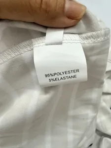 Detailed view of garment material composition label showing 95% polyester and 5% elastane.