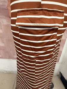 Detailed view of women's brown white striped knit bodycon skirt with pocket design.