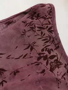 Détail de haut en mesh transparent avec magnifique motif de papillon en velours.
