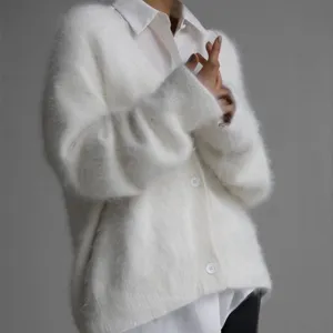 Soft fluffy white cardigan knit sweater detail, cozy winter style, elegant long sleeves.