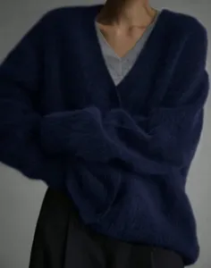 Detailed view of the cozy navy blue fuzzy V-neck cardigan showcasing soft knitted texture.