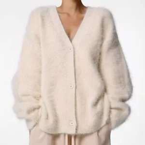 Cozy fuzzy V-neck cardigan detail, soft knit sweater texture, elegant autumn winter style.