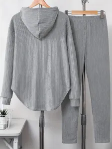 Detail view of the gray crinkled fabric texture, casual hooded sweatshirt and pants loungewear.