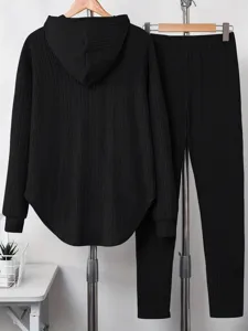 Black ribbed loungewear set featuring a long-sleeve hoodie and matching pants for women.